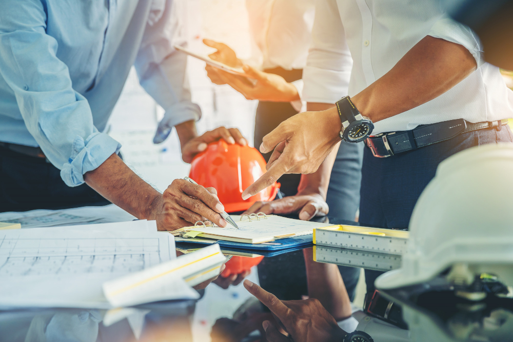contractor-engineer-with-blueprints-discuss-modern-construction-site-engineers-mechanical-factory-reading-instructions
